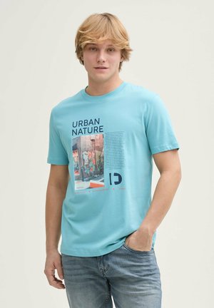 Light blue cotton t-shirt featuring a graphic print with text and a colorful urban mural, crew neck, and short sleeves.