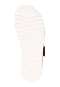 Semelle extérieure blanche texturée avec un motif ondulé, présentant un bout arrondi et une marque au centre. Section arrière en tissu de couleur marron.