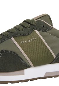 Zapatilla verde que combina ante y tejido, con una lengüeta acolchada, costuras tonales y una suela de goma blanca. Logo grabado en el lateral.
