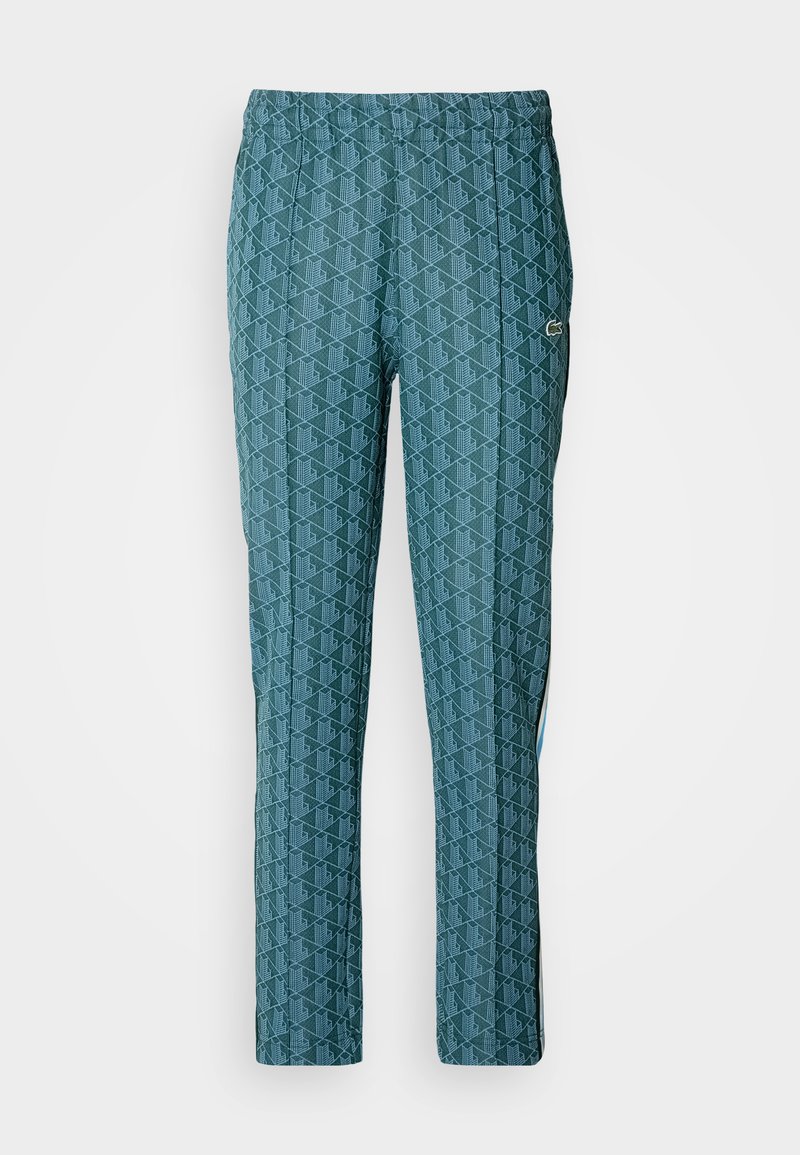 Pantalons turquoise à motifs avec un design géométrique texturé, taille élastique et bandes latérales de couleur contrastante.