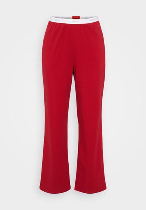 Red cotton lounge pants with a relaxed fit, featuring a white elastic waistband embossed with "HUGO." Straight-leg design.
