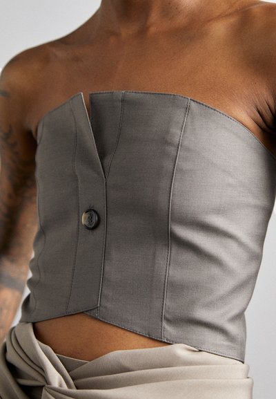 Gray, strapless top with structured design, single button closure, and subtle sheen. Features clean lines and fitted silhouette.