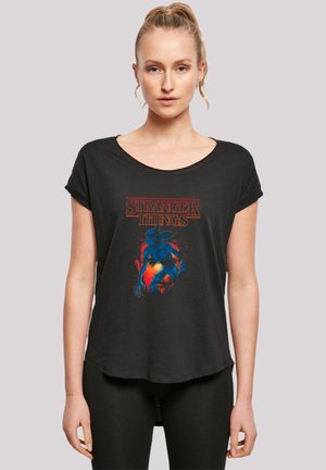 Black short-sleeve t-shirt featuring a colorful "Stranger Things" graphic, with a rounded neckline and a loose, relaxed fit.