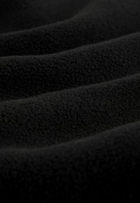 Black fleece fabric with a soft texture, featuring gentle waves and a smooth surface, creating a subtle, rich visual depth.