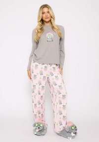 Gray long-sleeve pajama top with a cartoon character; pink pajama bottoms with a pattern of gray characters; gray animal slippers with accents.