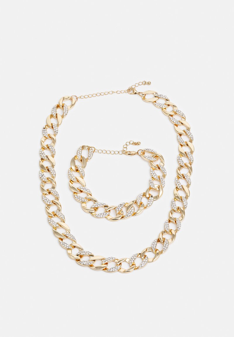 Gold-tone chain jewelry set featuring large links and rhinestone accents. Includes a necklace and bracelet, both with adjustable clasps.