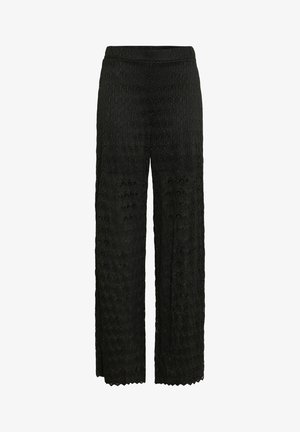 Schwarze weit geschnittene Hosen mit einer Spitze-Overlay, die ein strukturiertes Blumenmuster aufweist. Vollständiges Design mit einem elastischen Bund für zusätzlichen Komfort.