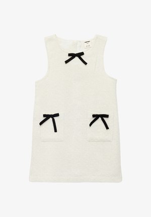 White sleeveless dress made of textured fabric, featuring two front pockets with black ribbon bows and a circular neckline.