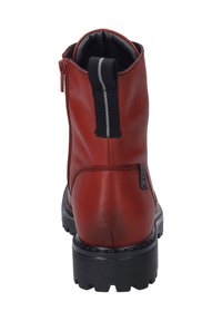 Bottine en cuir rouge avec semelle en caoutchouc noir, fermeture éclair à l'arrière et languette à rayures. Texture lisse et design structuré.