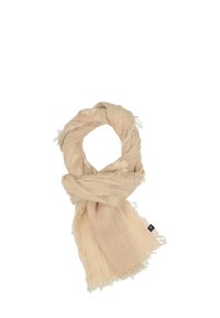 Écharpe beige avec un design tissé texturé, présentant des bords à franges. Tissu léger présenté en arrangement en boucle.