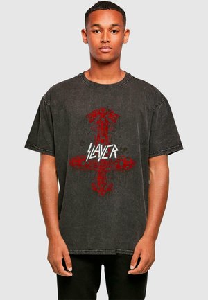 Black graphic t-shirt featuring a distressed design with red elements and the text “SLAYER” in white, short sleeves, and a relaxed fit.