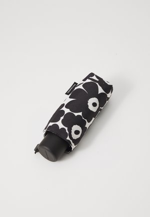 Black and white umbrella featuring a floral pattern. The handle is black, and it is folded within a fabric cover with a floral design.