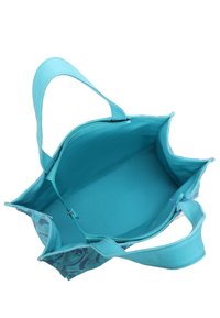 Sac fourre-tout en tissu teal avec un extérieur à motifs. Doté de poignées douces et d'une doublure intérieure lisse, spacieux avec une poche zippée.
