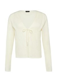 Gilet couleur crème avec décolleté en V et manches longues, présentant un lien sur le devant et un motif en cœur texturé sur l'ensemble.