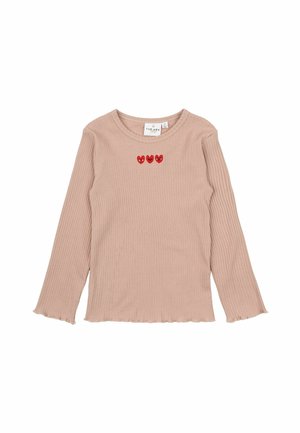 Langærmet beige ribstrikket skjorte med rund hals og tre små røde hjerter med ansigter broderet på brystet.