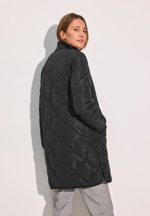 Black quilted long jacket with a stand-up collar. Features diamond pattern and side pockets, made from smooth, lightweight fabric.