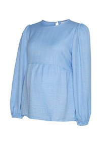 Blouse bleu clair à manches longues avec un col rond, des manches froncées et une coupe ample. Conçue en tissu texturé avec un motif subtil.