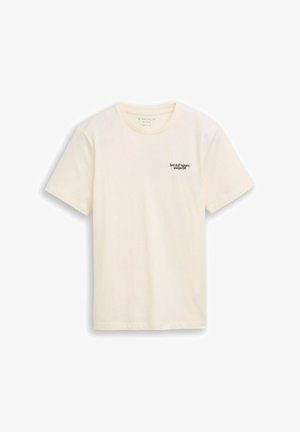 Tricou din bumbac crem, cu mâneci scurte și decolteu rotund. Prezintă textul negru "cele mai bune lucruri se întâmplă neașteptat" pe partea stângă a pieptului.