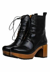 Black leather high-heeled boots with a lace-up design, featuring a chunky brown platform sole and textured accents on the sides.