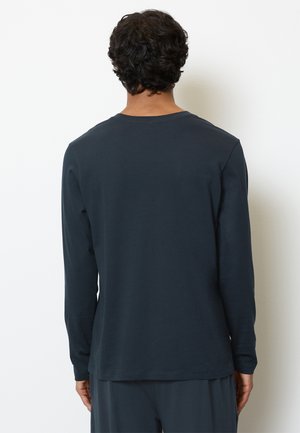Marineblauwe langemouwen T-shirt van zacht katoen. Kenmerkt zich door een ronde halslijn en een relaxte pasvorm met een gladde textuur. Geen zichtbare patronen of accenten.