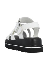 White leather sandal with open straps, a silver accent buckle, and a black rubber sole featuring white detailing and textured midsole.
