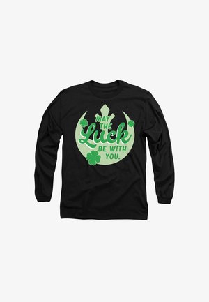 Black long-sleeve shirt featuring green graphic text saying "May the Luck Be With You" and clover illustrations. Simple and symmetrical design.