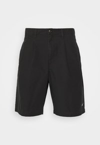 Black shorts made of fabric with a smooth texture, featuring a button closure, pleats in the front, and a small logo on the hem.