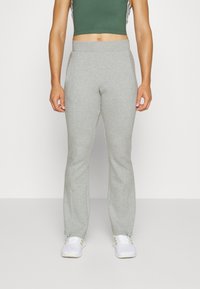 Grijze sportbroek met een tapered fit, elastische tailleband en zijzakken, gemaakt van zachte, getextureerde stof, geschikt voor actieve kleding.