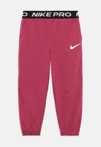 Spodnie dresowe Nike Pro w kolorze różowym, wykonane z miękkiego materiału. Posiadają czarny elastyczny pasek w talii z napisem "NIKE PRO" oraz białym logo.