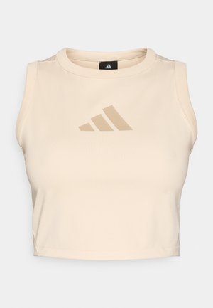 Bēšs kropta tops no gludas auduma ar apaļu izgriezumu. Priekšpusē ir diskreta bēša Adidas logo. Piedurkņu trūkums.