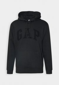 Black hoodie with a large front pocket, drawstring hood, and embossed "GAP" logo in matching color. Made of soft fabric with ribbed cuffs.