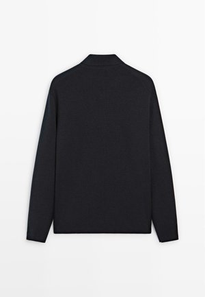 Dark navy long-sleeve pullover, made of soft knit material, featuring a classic collar and subtle raglan sleeves, minimalistic design.