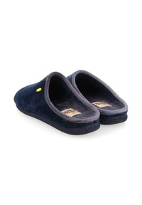 Chaussons bleu marine en suède doux, dotés d'un doublure en peluche, d'une forme arrondie et d'un petit logo jaune sur le côté. Semelles en caoutchouc plates.