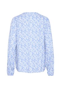 Blouse bleu clair avec un motif abstrait texturé blanc. Dotée de manches longues et d'un décolleté arrondi et décontracté.