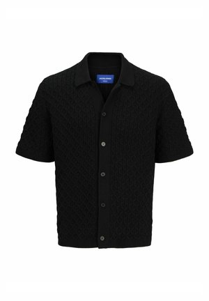 Black short-sleeve cardigan with a textured diamond pattern, button front closure, and a collared neck. Made from a cozy knit material.
