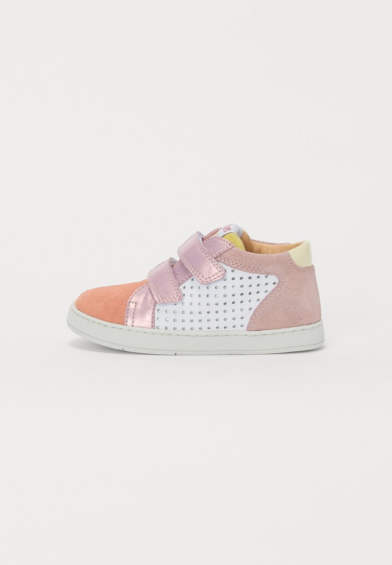 Sneakers with a pink suede toe, white perforated upper, and pink metallic accents. Features two velcro straps and a white rubber sole.