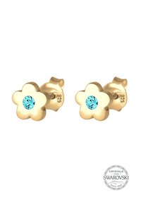 Guldbelagte blomsterformede studs med en blå Swarovski-krystal i midten, med en glat og poleret overflade.
