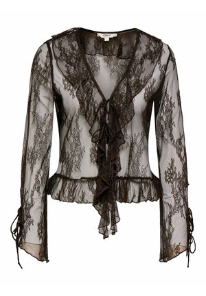 Blouse noire en dentelle transparente avec manches longues, encolure en V à volants, fermetures à nouer sur le devant, et ourlet ainsi que poignets à volants.