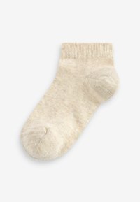Chaussette en coton beige avec une bordure côtelée, un orteil sans couture et une texture douce. Design mi-mollet adapté pour un port décontracté.