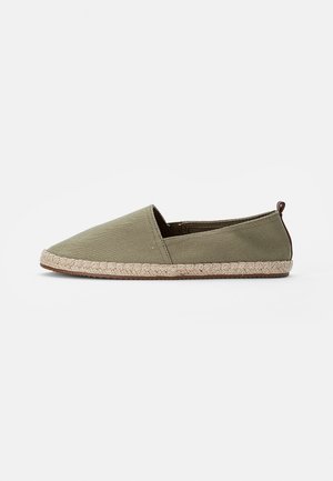 Green canvas espadrille with slip-on design, round toe, and jute rope sole. Includes a small brown tab at the heel.