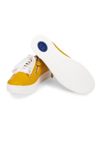 Yellow sneakers with glossy synthetic upper, white laces, and zip detail. Features a white rubber sole with a blue circular accent on the bottom.