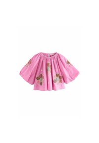 Blouse en coton rose avec des manches ballon, ornée d'appliqués de fleurs en forme d'hexagone de différentes couleurs et de petits détails brodés.
