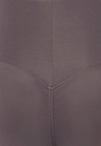 High-waisted, dark purple leggings made of stretchy fabric. Features flat seams and a smooth texture, with an angled design on the back.