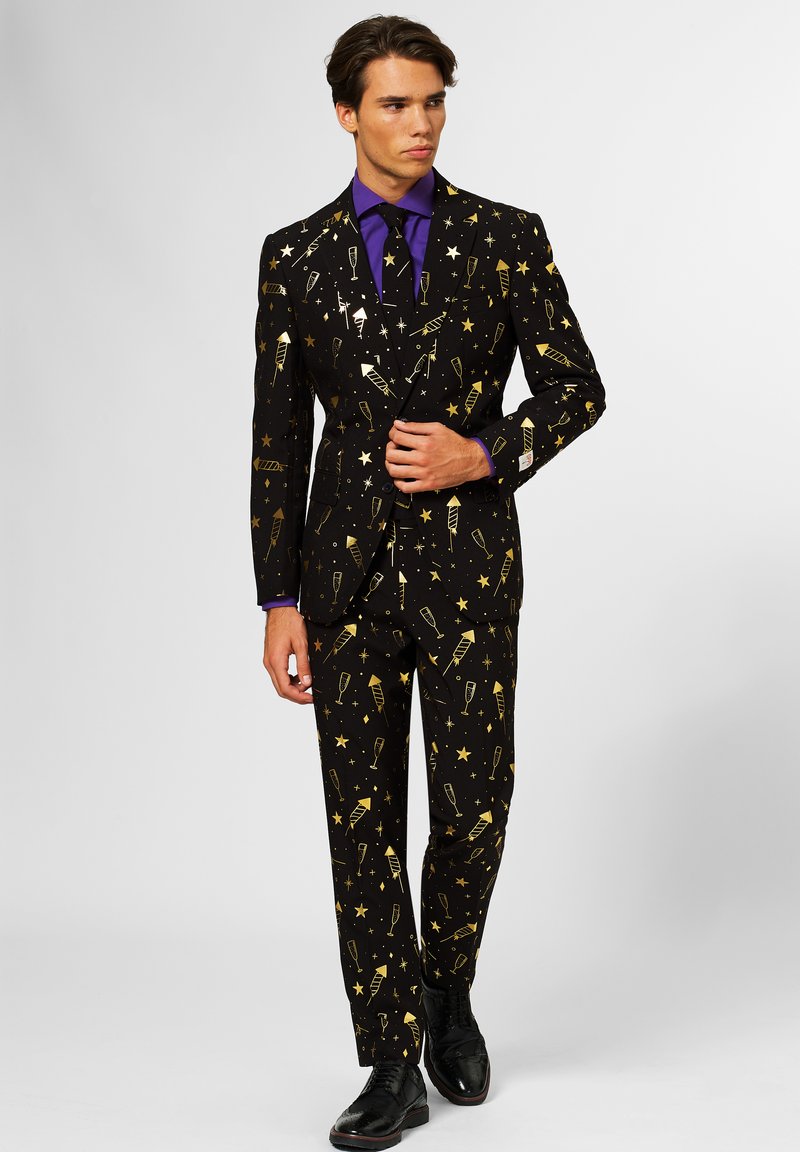 Black suit with gold pattern featuring stars and celebration icons. Includes matching pants, complemented by a purple shirt and black shoes.