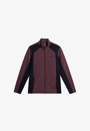 Mörkröd och svart zip-up-jacka med ståkrage, med kontrasterande sidopaneler och två framfickor med dragkedja. Mjuk, slät textur.