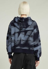 Kurz geschnittenes Hoodie in Marineblau und Grau mit abstrakten Mustern, weichem Stoff und einer Kapuze mit Kordelzug. Verfügt über gerippte Bündchen und Saum.