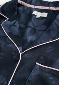 Navy floral-patterned silk pajama shirt with pink piping and a breast pocket. Features a tag reading "By Ted Baker London."