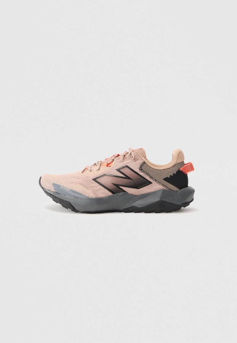 Light pink and black athletic shoe with gray sole, featuring "N" logo and orange pull tab at heel, shown from left side.