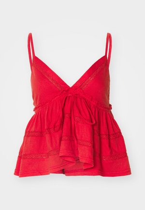 Top senza maniche in cotone rosso con scollatura a V, spalline regolabili, vita arricciata e dettagli in pizzo testurizzato sul corpo e sull'orlo.