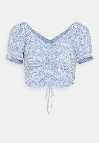 Top corto floral azul con mangas abullonadas, detalle fruncido en la parte delantera y un cordón en el dobladillo. Fabricado en tejido ligero.